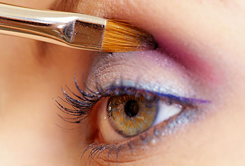 getty_rm_photo_of_woman_applying_bright_eye_shadow